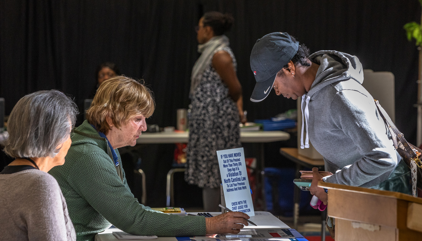 Election workers assisting a voter