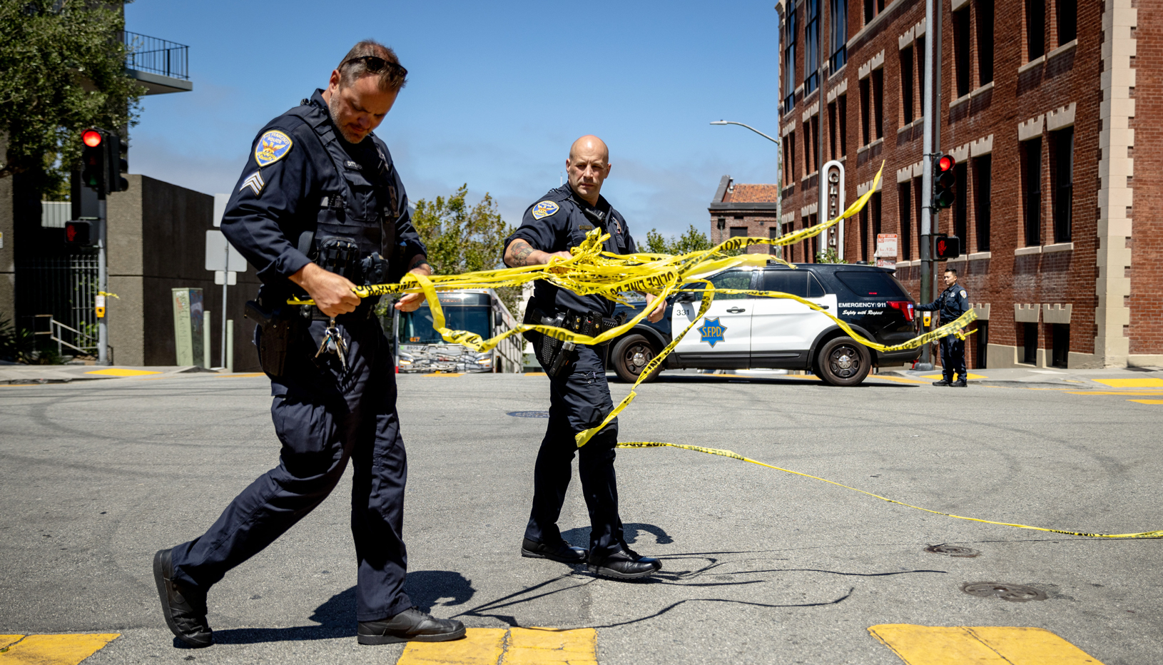 Police officers handling crime scene tape