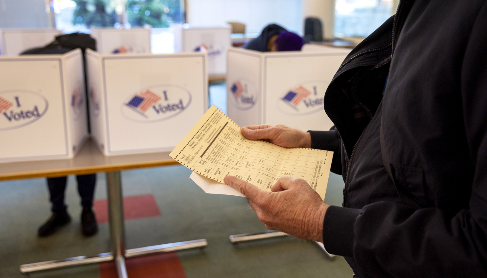 person holding paper ballot