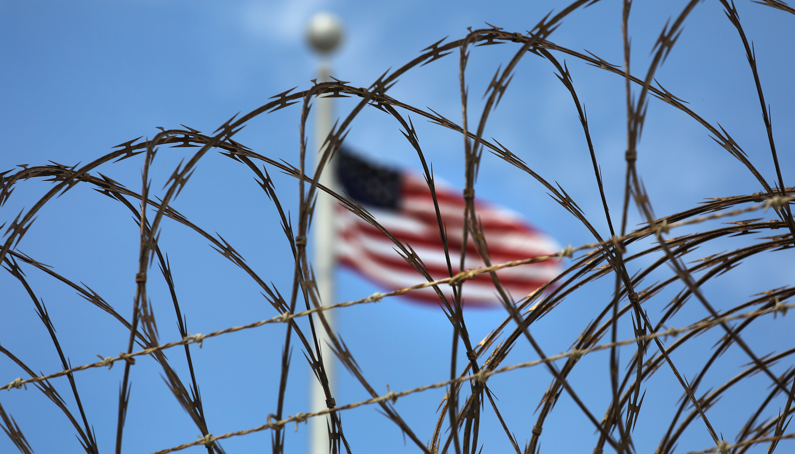 Flag behind barbed wire