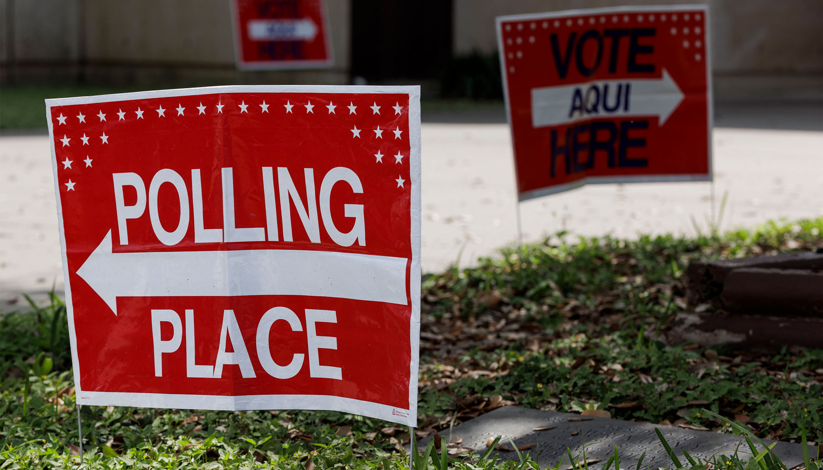 Red polling place sign with arrow