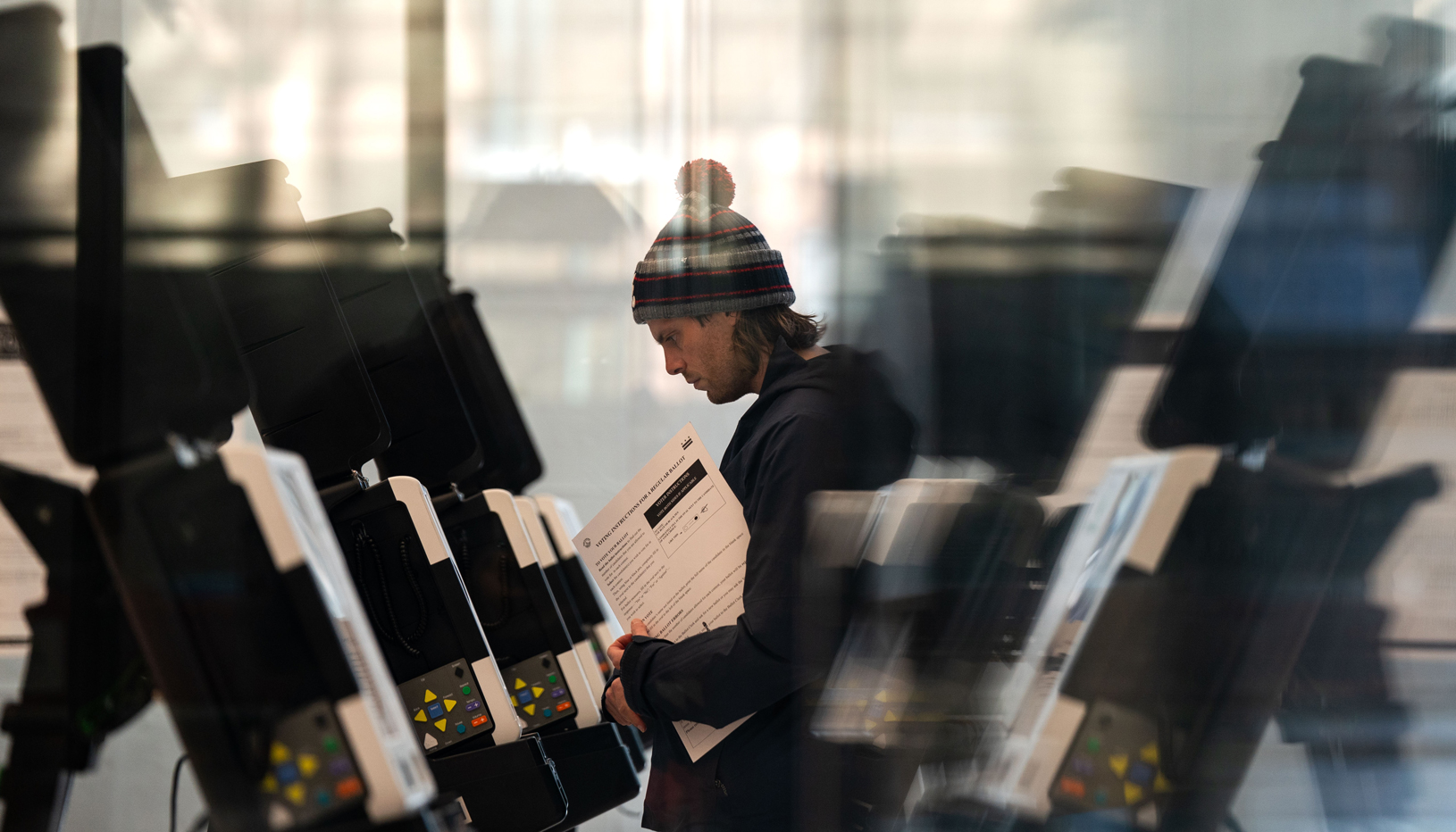 Man voting at line of voting booths