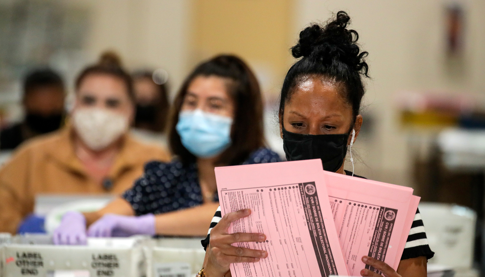 Election workers reviewing ballots