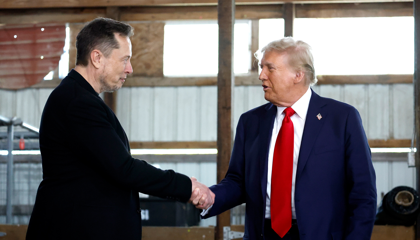 Elon Musk shaking hands with Donald Trump