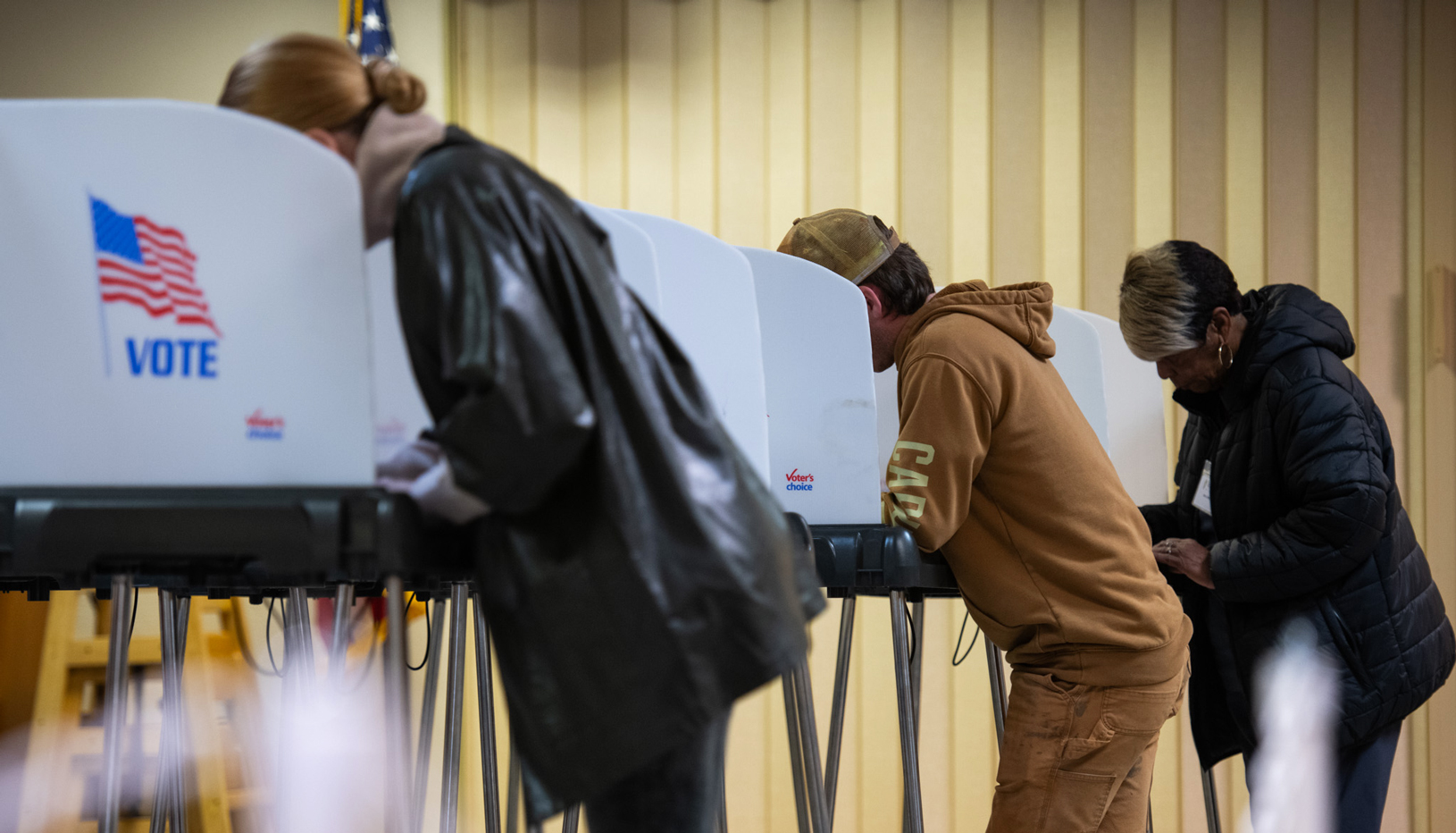 People casting ballots at the voting booth.