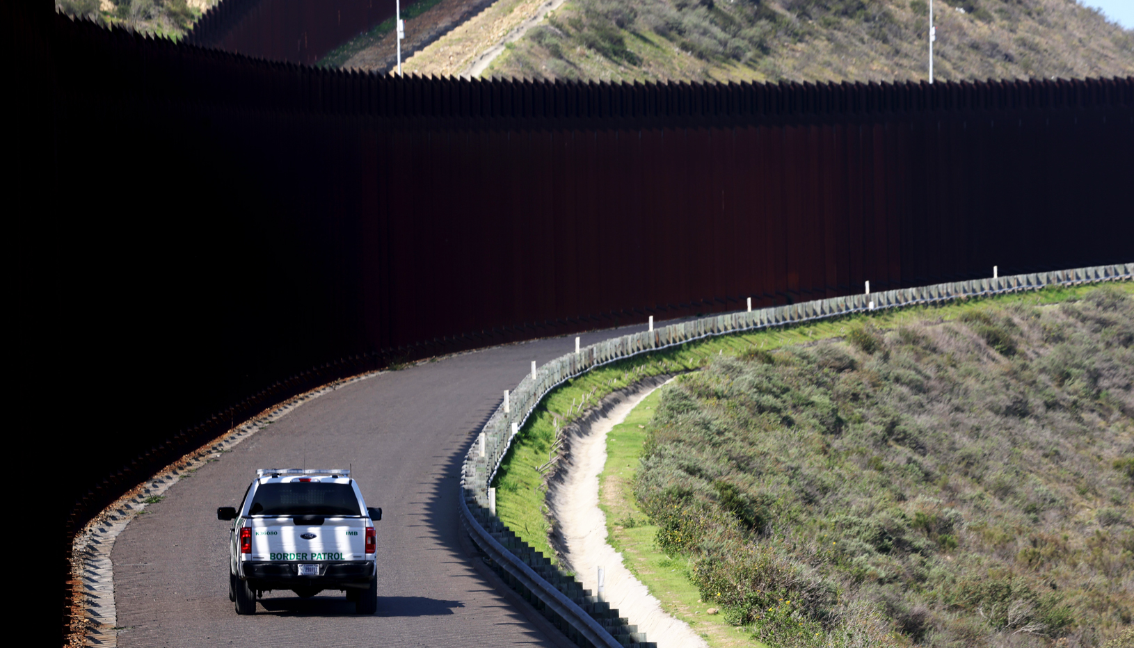 Border Patrol car driving along U.S.–Mexico border