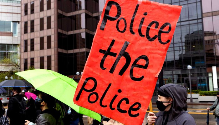 Protester holds sign, 