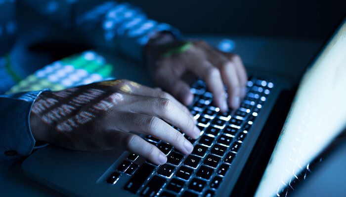 hands typing on computer keyboard