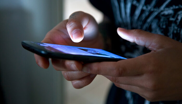 Close-up shot of hands using a cell phone