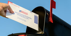 Mail ballot going into a mail box