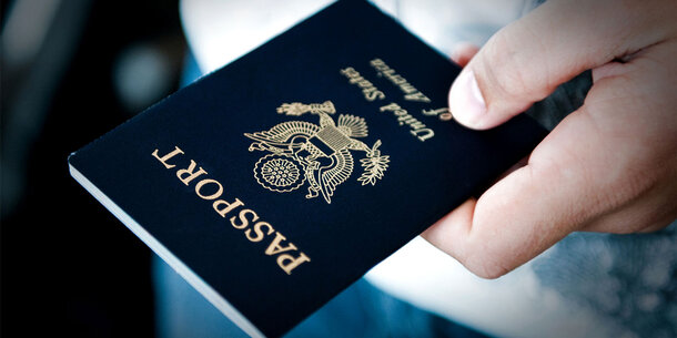 Hand holding U.S. passport
