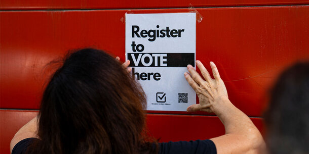 A register to vote sign.