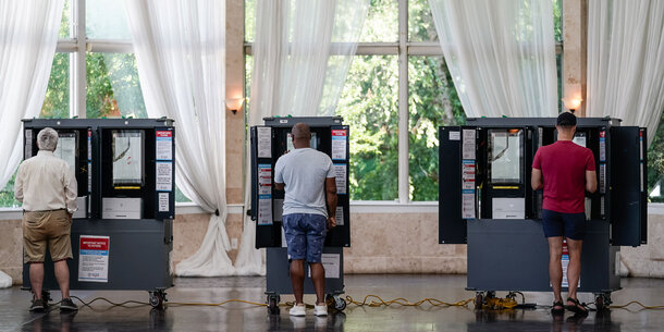 People at voting booths