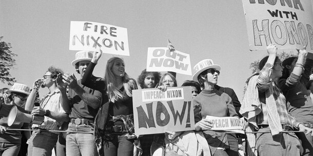 Protesters holding anti-Nixon signs in 1974