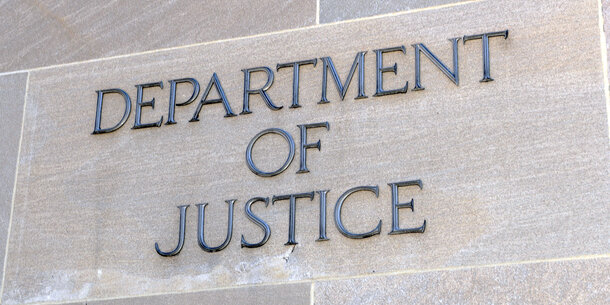 Department of Justice lettering on gray building