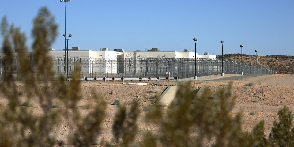 prison and fence with plants in foreground